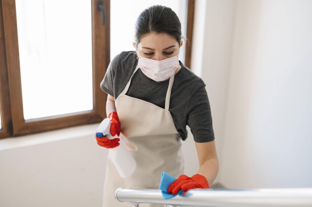 medium-shot-woman-cleaning-railing-min